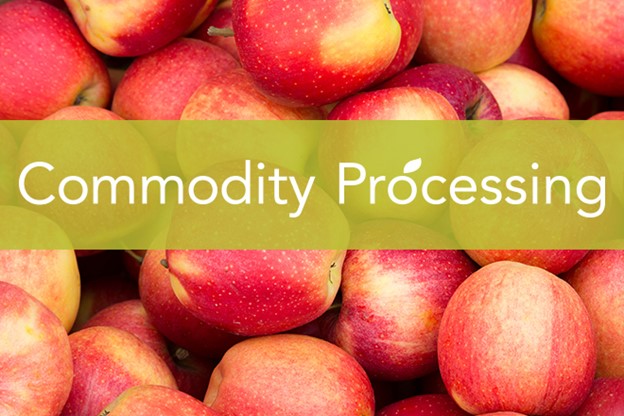 Group of apples with text banner across image that states commodity processing