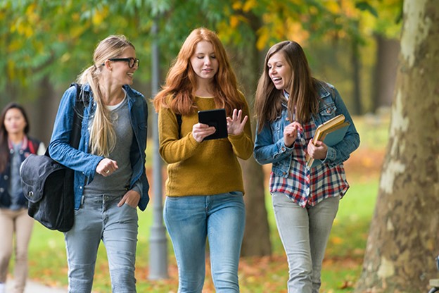 Three female college students walking outdoors